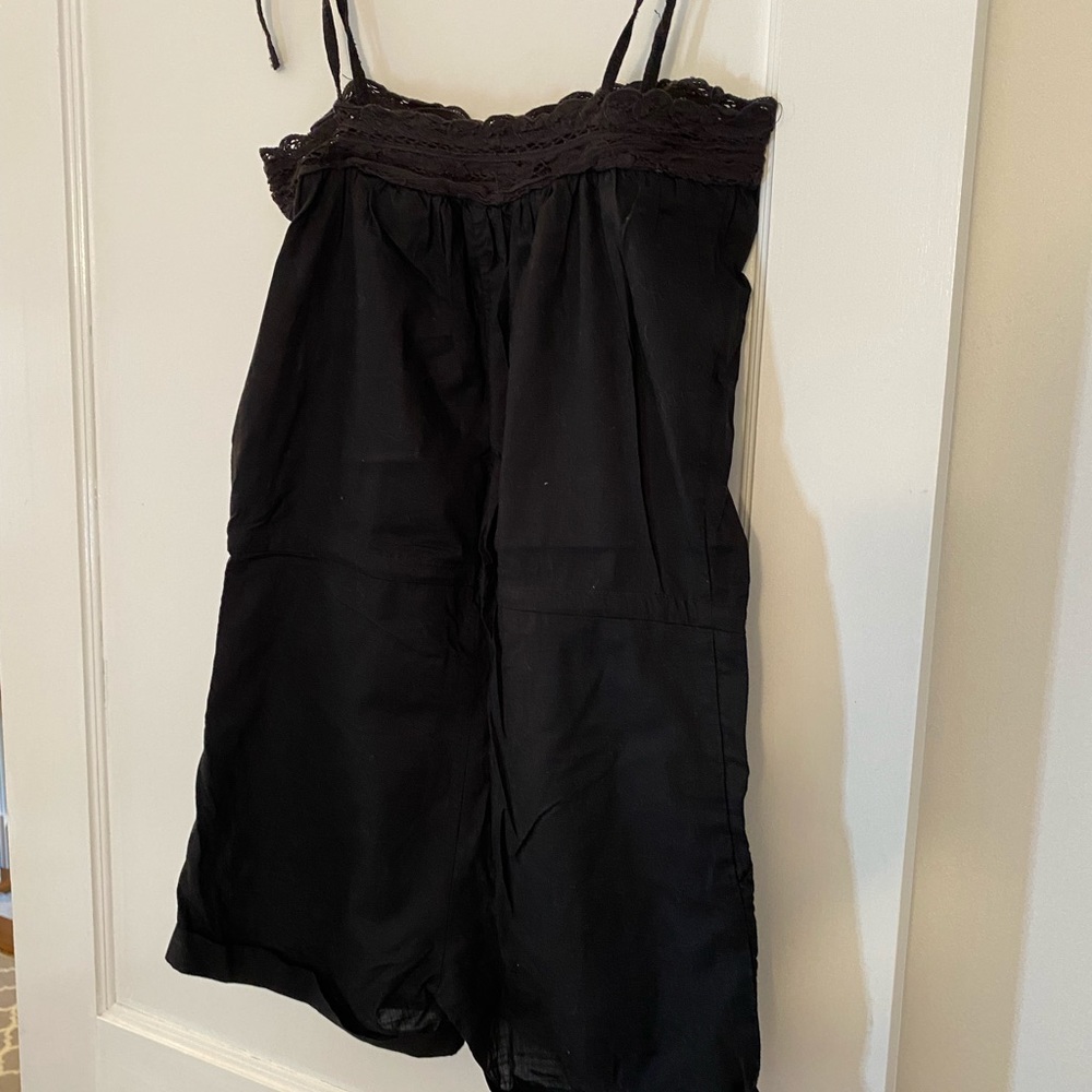 H&M black shorts romper has lace detail at neck and pockets. Size 2.